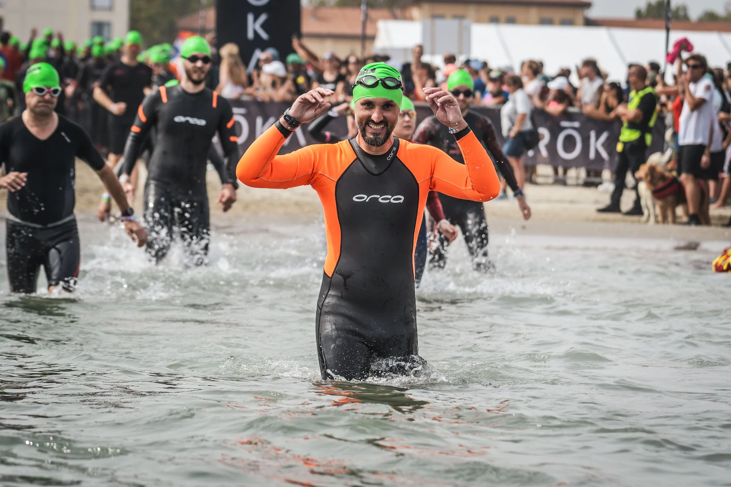 Triathlete swimming in open water at the start of a race